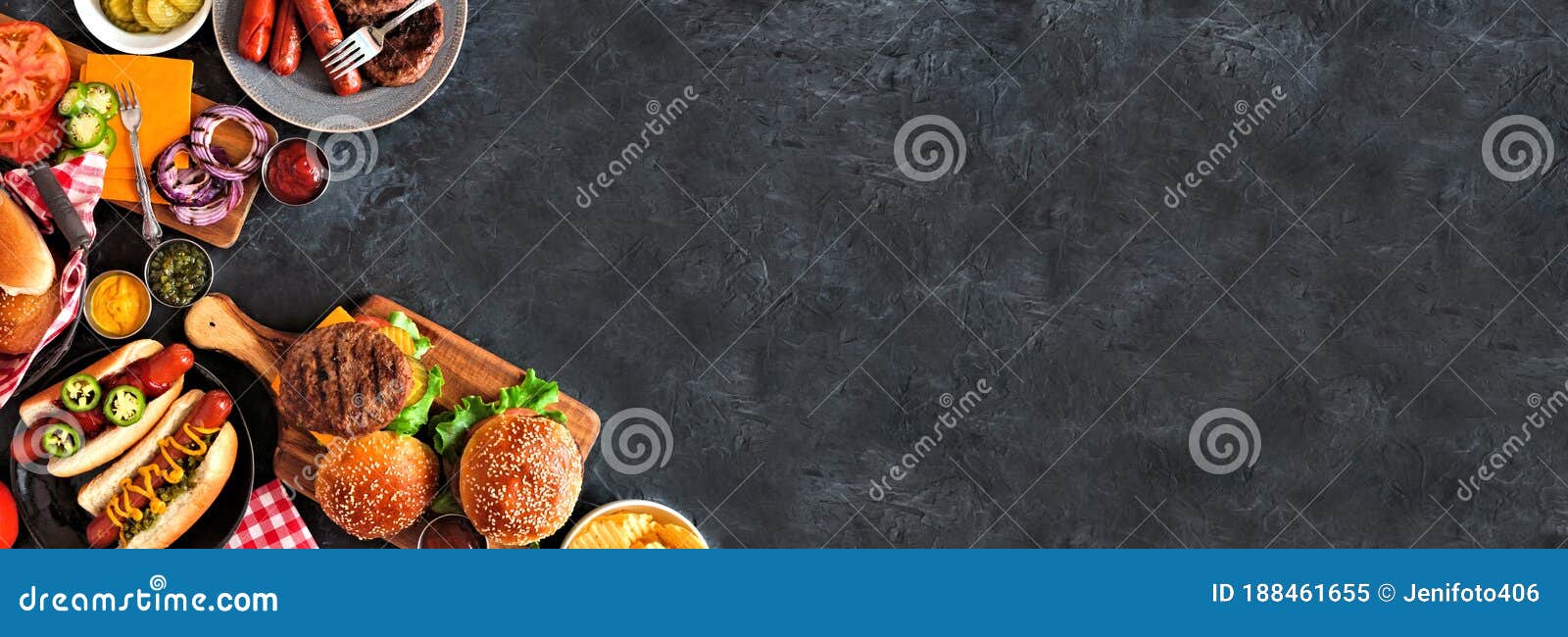 summer bbq food corner border with hot dog and hamburger buffet, top down view over a dark banner background