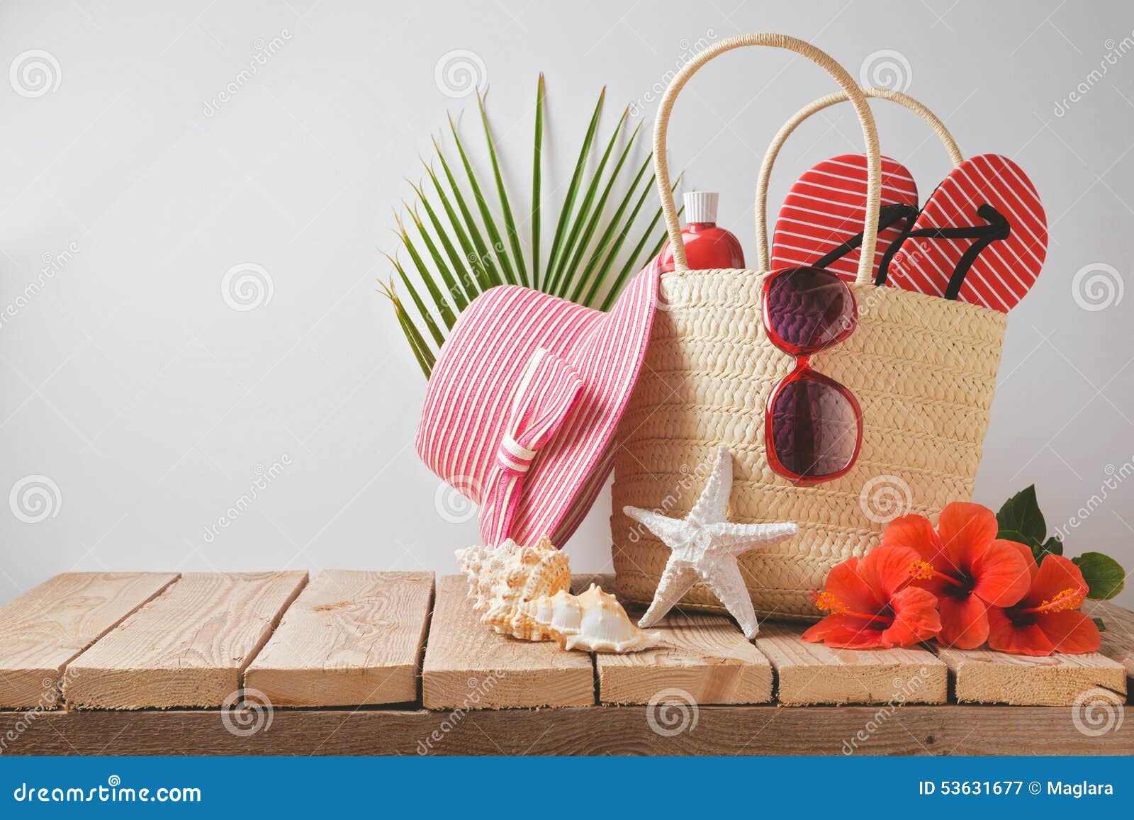 Summer Beach Bag And Hibiscus Flowers On Wooden Table 