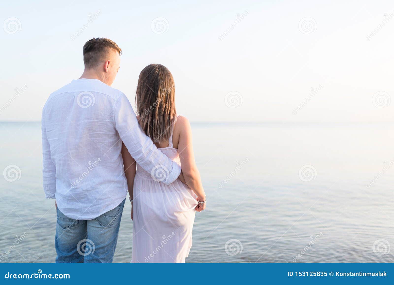 Summer Couple Embracing at Sunset on Beach. Romantic Young Couple