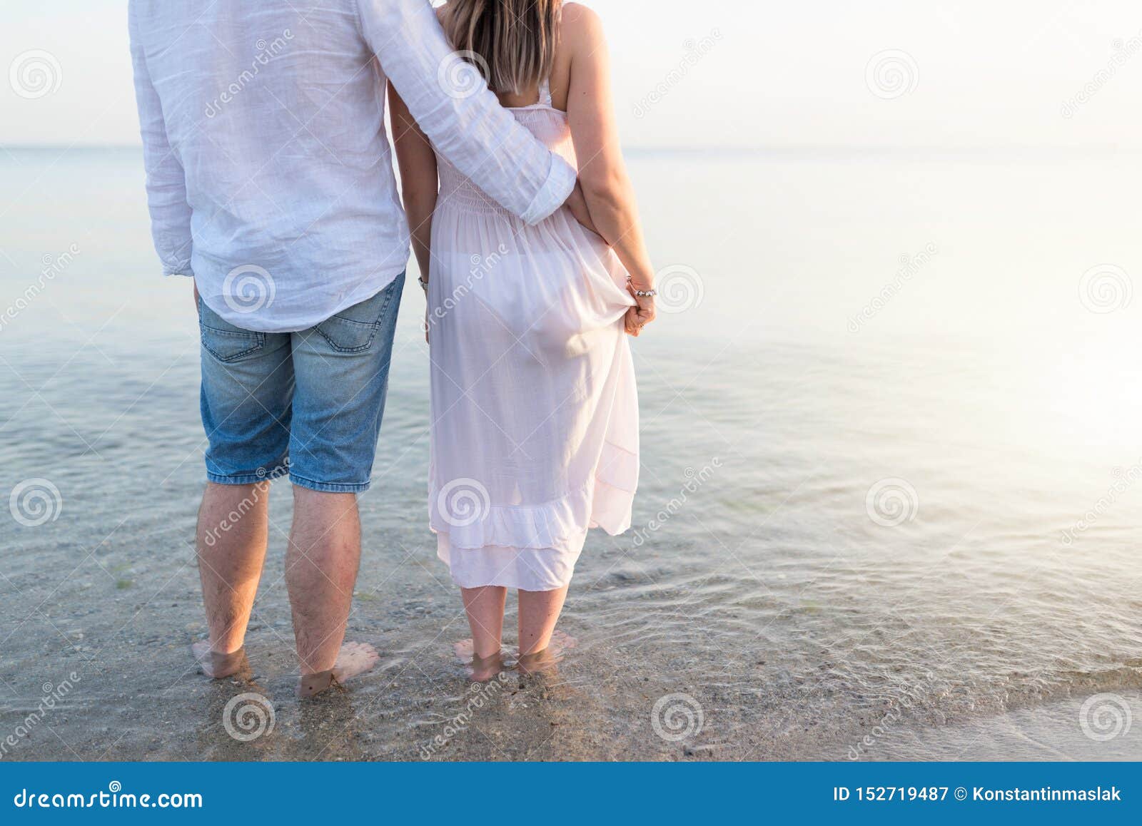 Summer Couple Embracing at Sunset on Beach. Romantic Young Couple