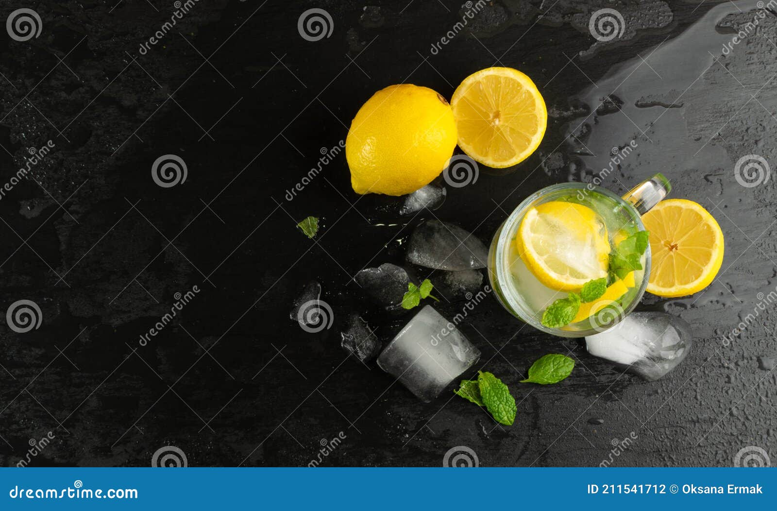 summer lemonade with ice cubes and fresh lemon