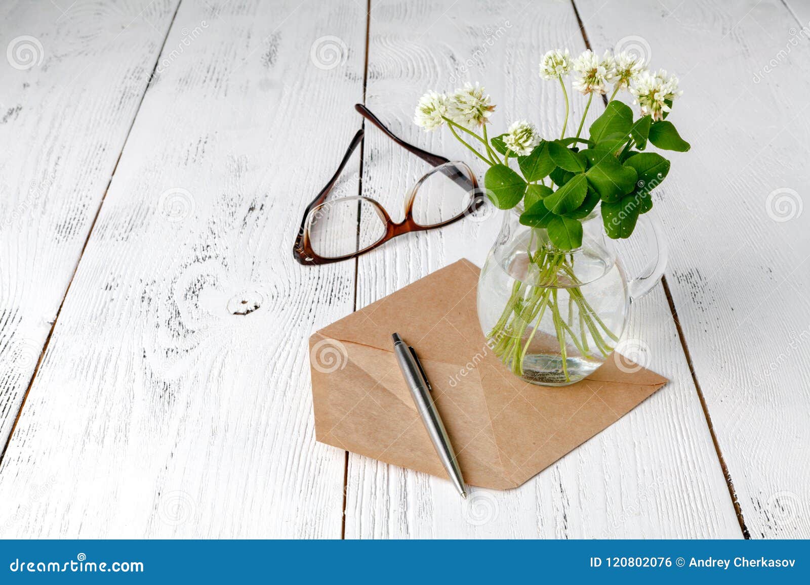 summer mood with white clover on wooden table