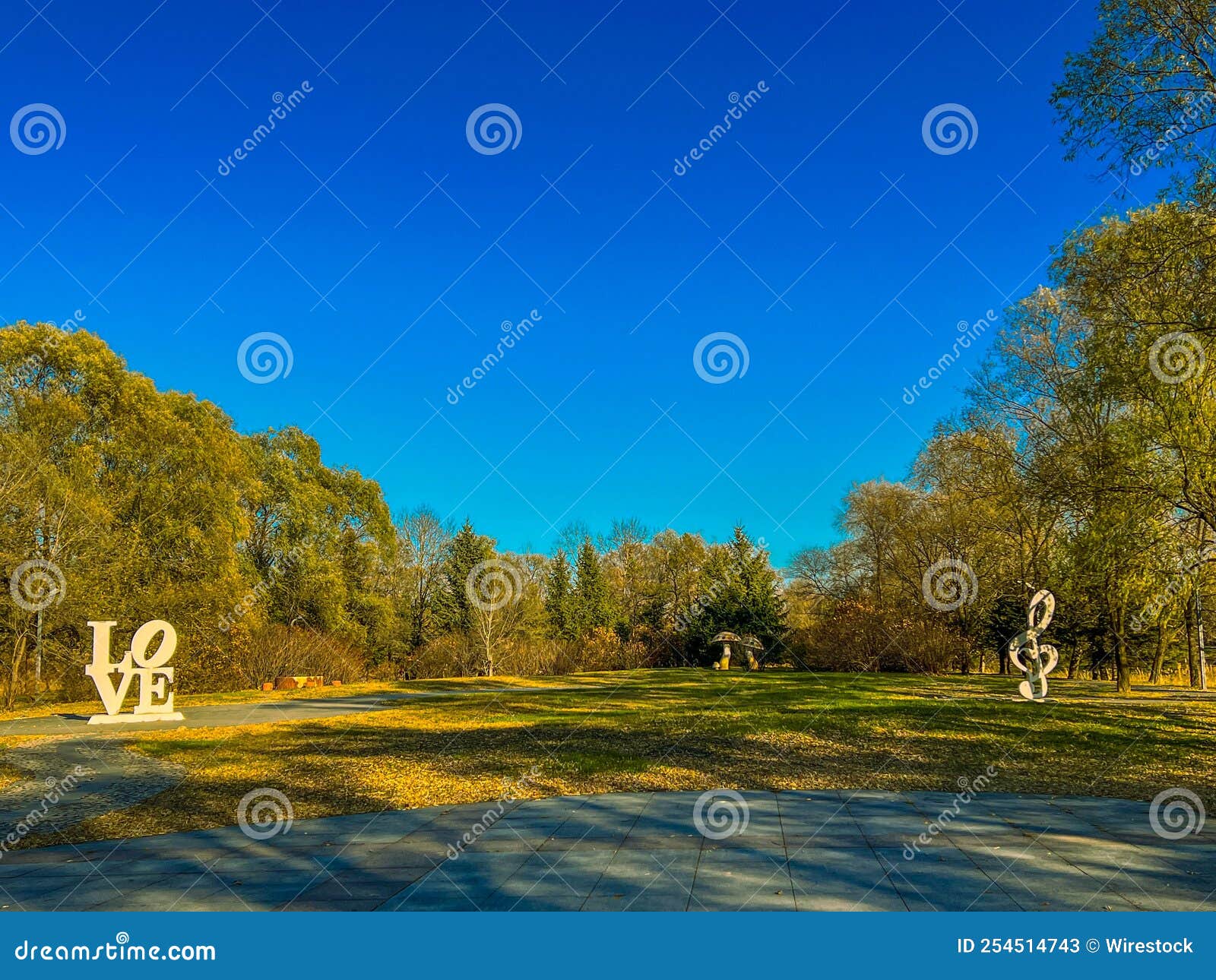 summer park scene with love text, clave de sol sign and mushrooms sculptures