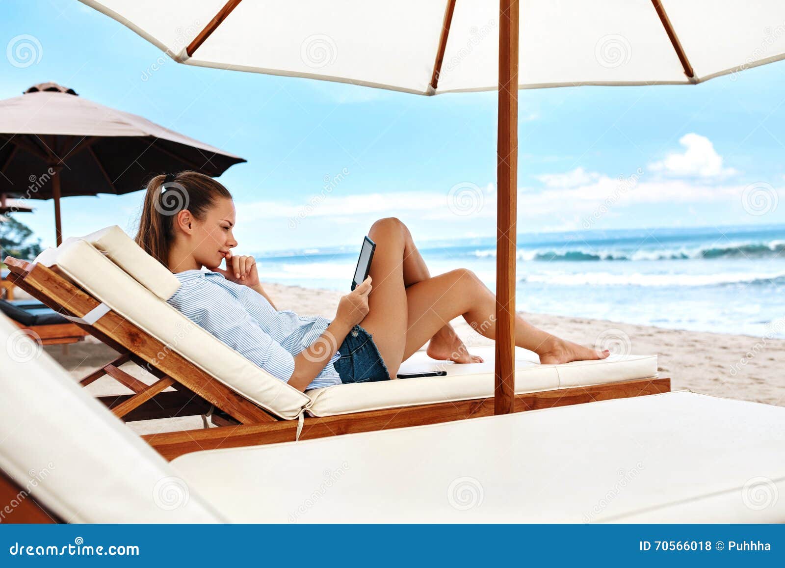 summer relaxation. woman reading, relaxing on beach. summertime