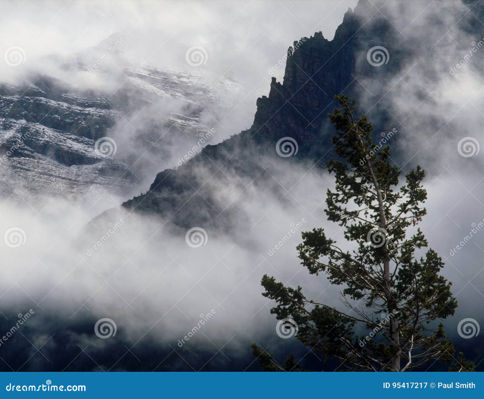 summer snowfall and clearing storm in the lewis range, glacier national park, montana