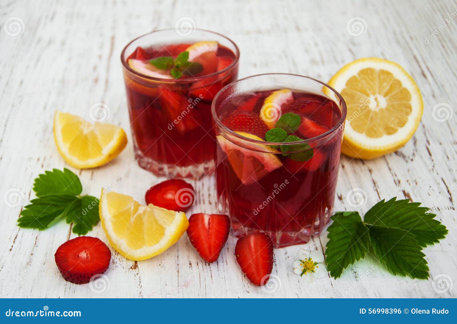 Summer strawberry drink. Glasses with strawberry drink on a wooden background