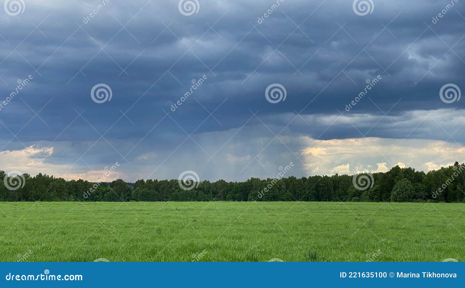 Summer Thunderstorm. Stormy Dramatic Sky and Green Field Stock Photo
