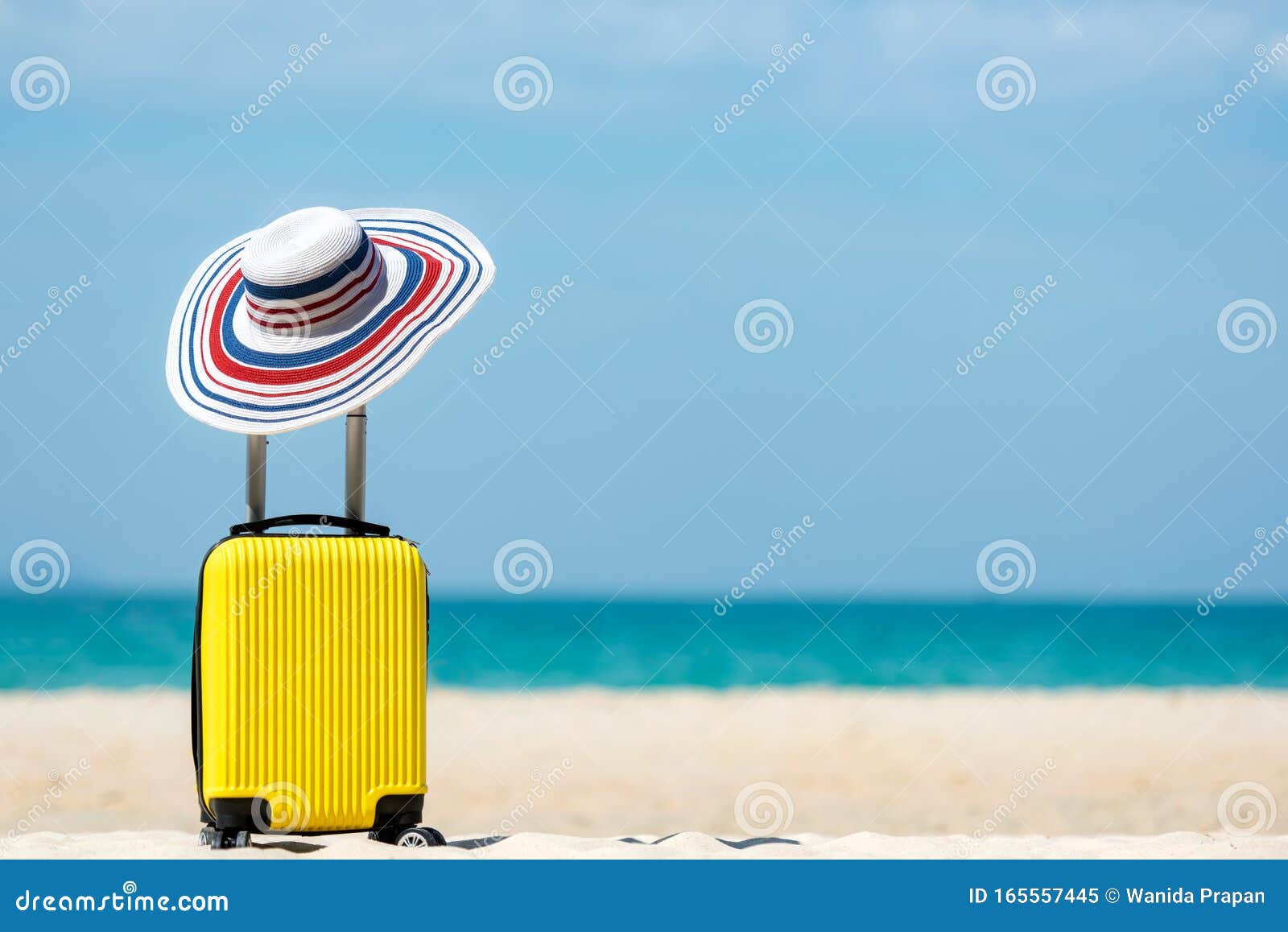summer travel and plan with yellow suitcase luggage in the sand beach. travel in the holiday trips, airplane and blue sky backgrou