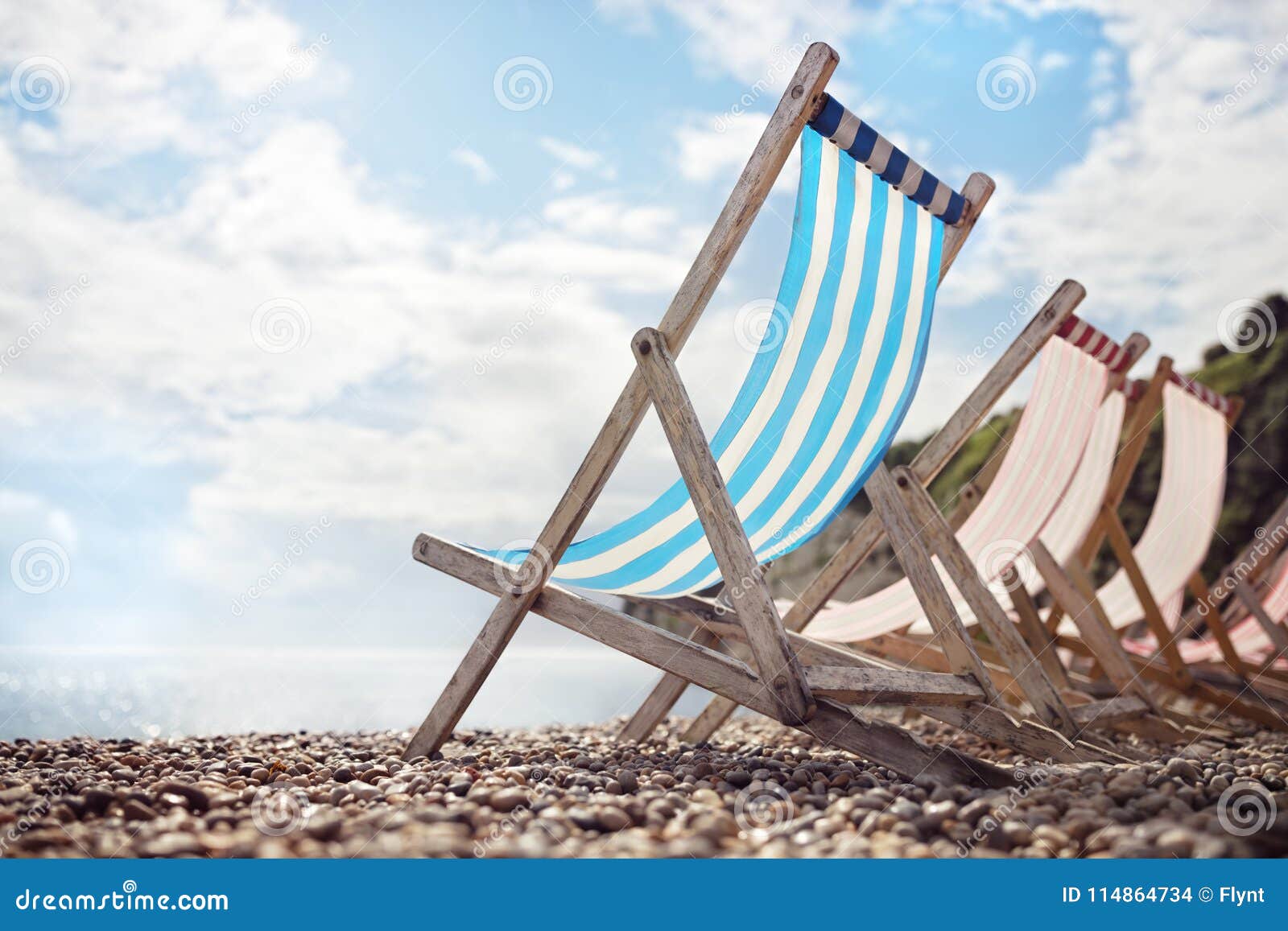 summer vacation deck chairs on the beach at the seaside