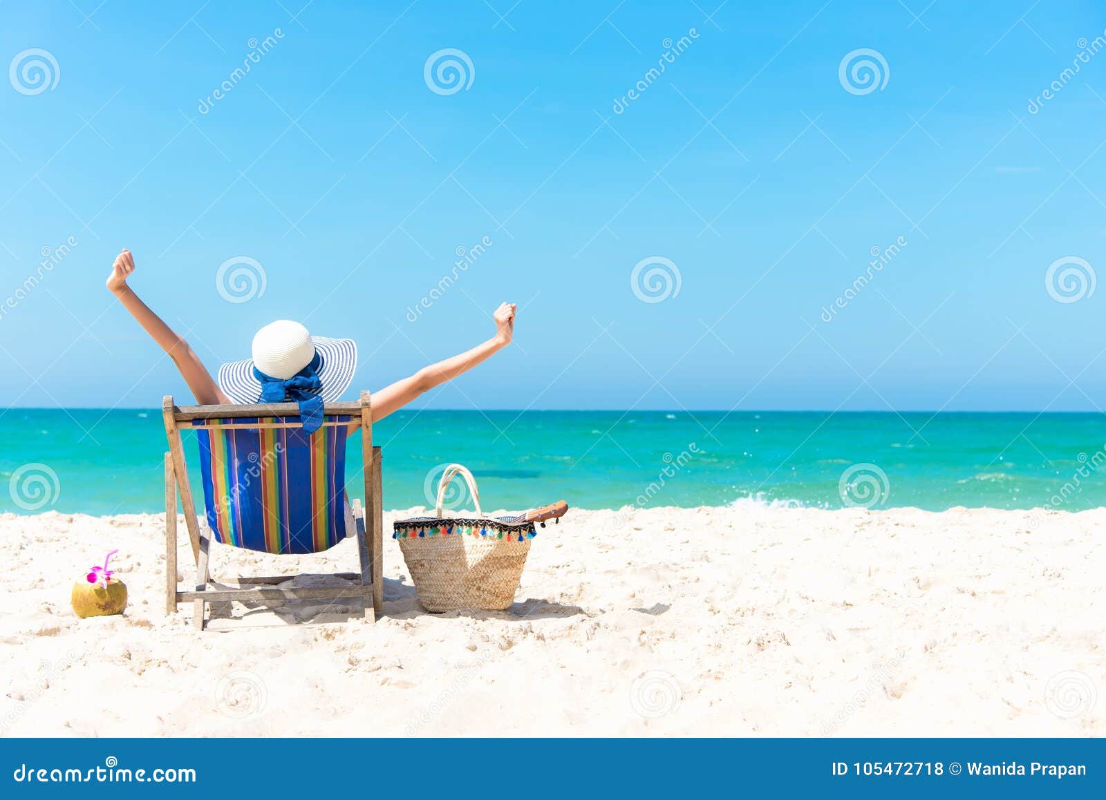 summer vacation. beautiful young asian woman relaxing and happy on beach chair with cocktail coconut juice