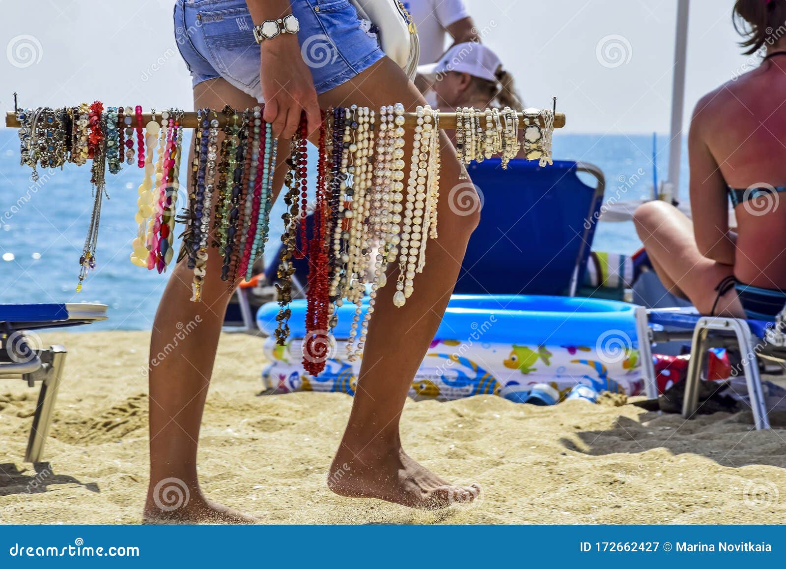 Summer Vacation Holiday Legs Of Girl Selling Jewelry On Beach