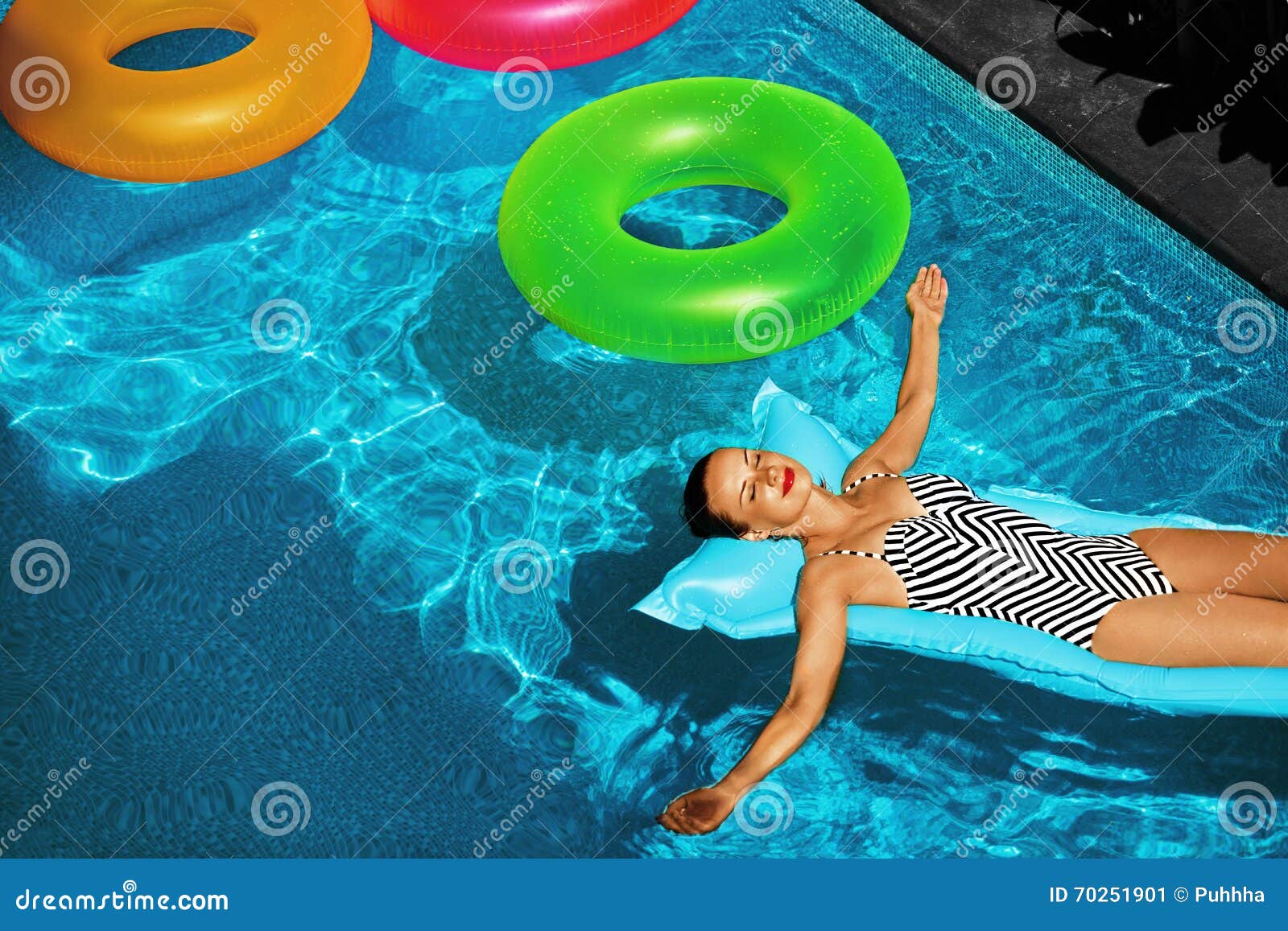 summer vacations. woman sunbathing, floating in swimming pool water