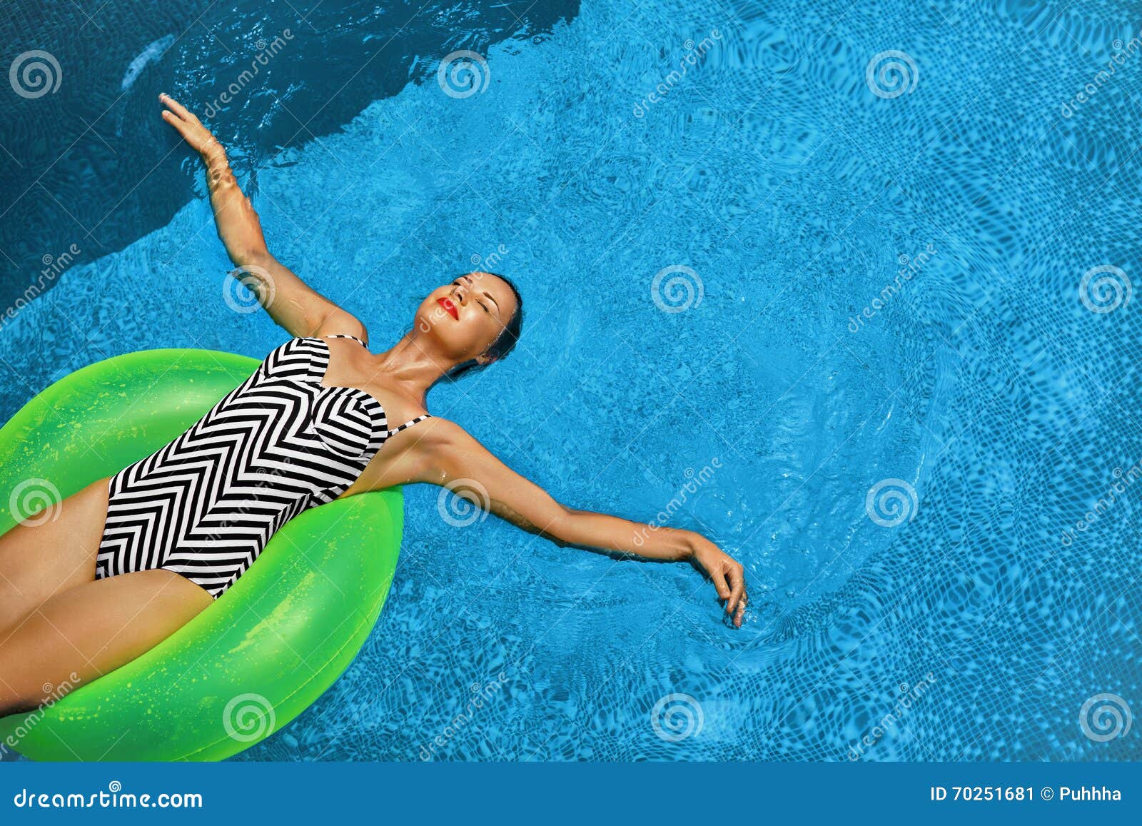 summer vacations. woman sunbathing, floating in swimming pool water