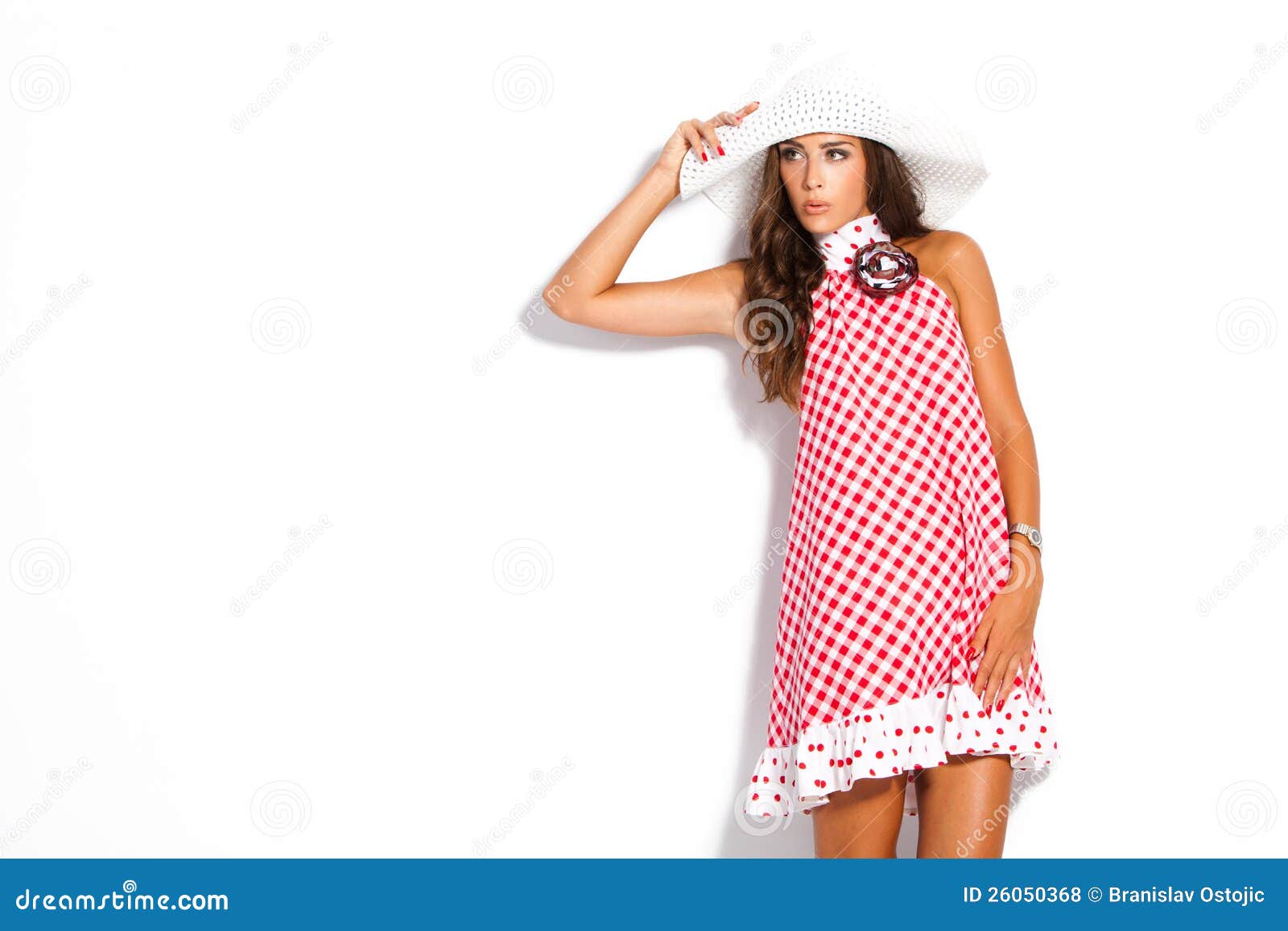 Summer woman. Young fashion model in summer dress abd hat studio white