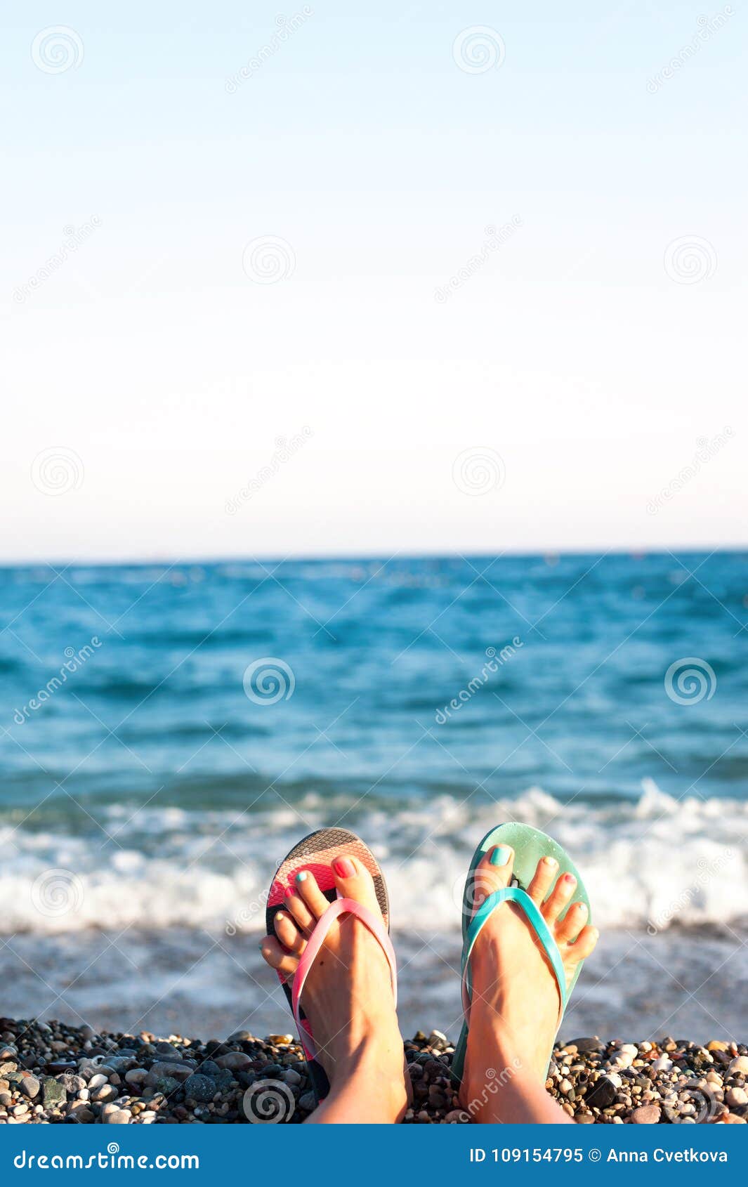 Summertime Enjoyment! Feet on the Beach. Blue Ocean Waves Background ...