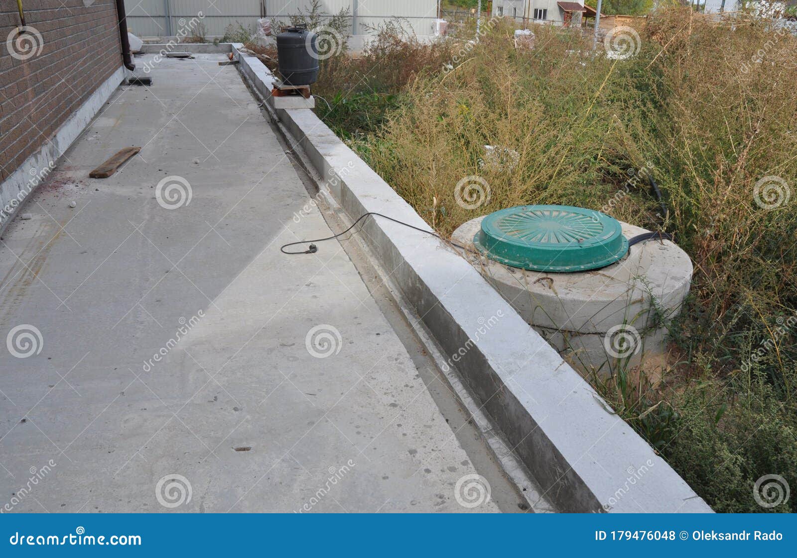 A Sump Pump, Septic Tank in the Back Yard of the House Stock Photo