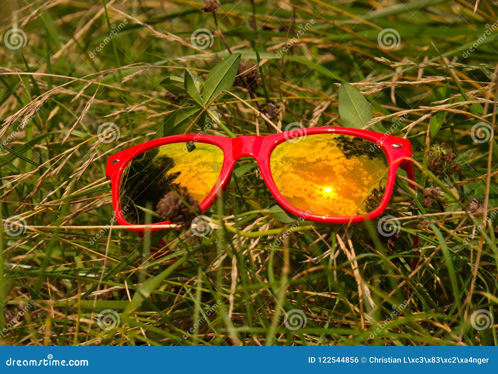 Sun and Cloud Reflection in the Glass of a Red Sunglasses Stock Photo ...