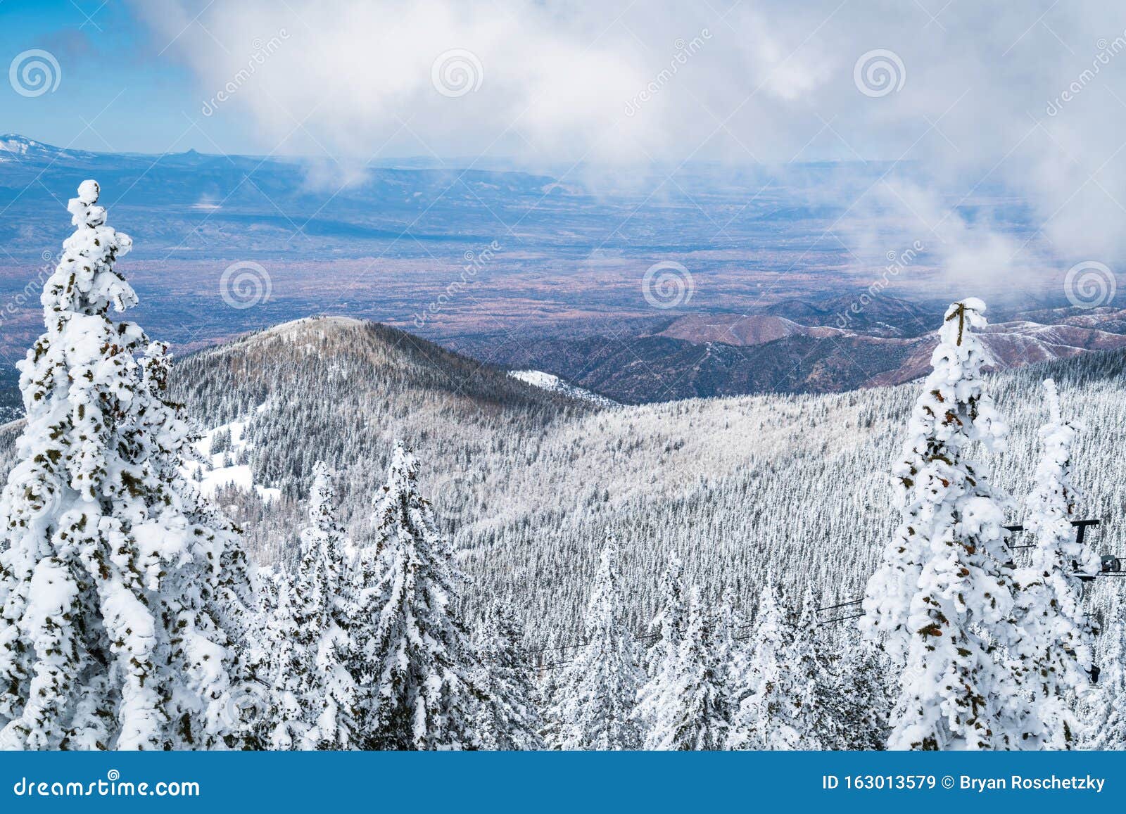 sun comes out after a snowy blizzard blankets the mountains with snow