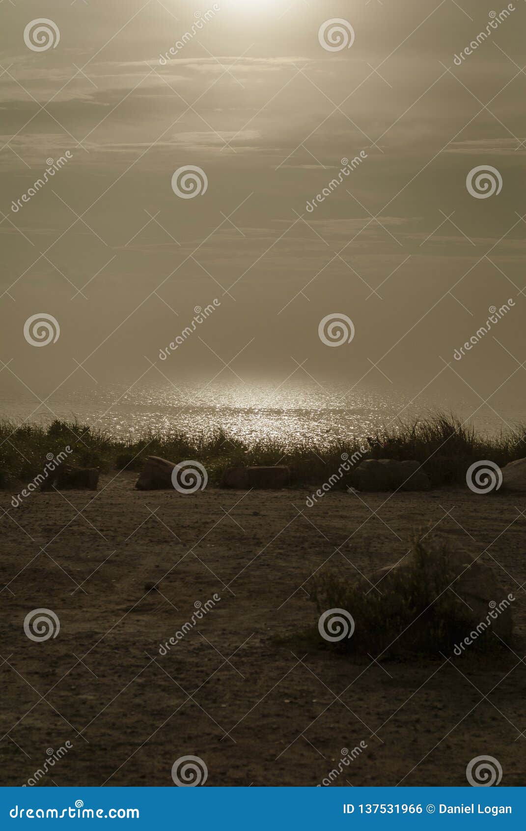 sun cuts hazy path across buzzards bay