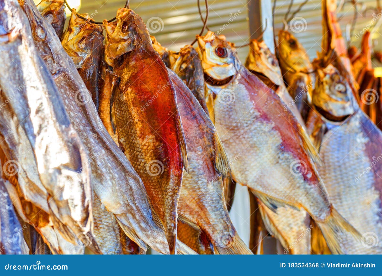 sun-dried breams hang on iron hooks