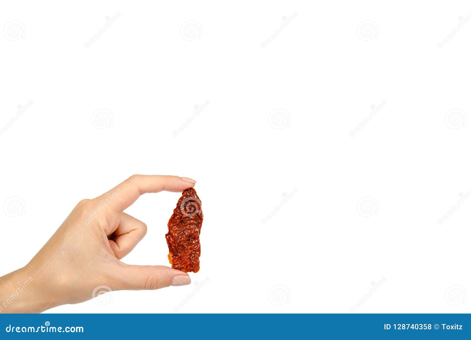 sun dried red tomatoes with hand  on white background, copy space template