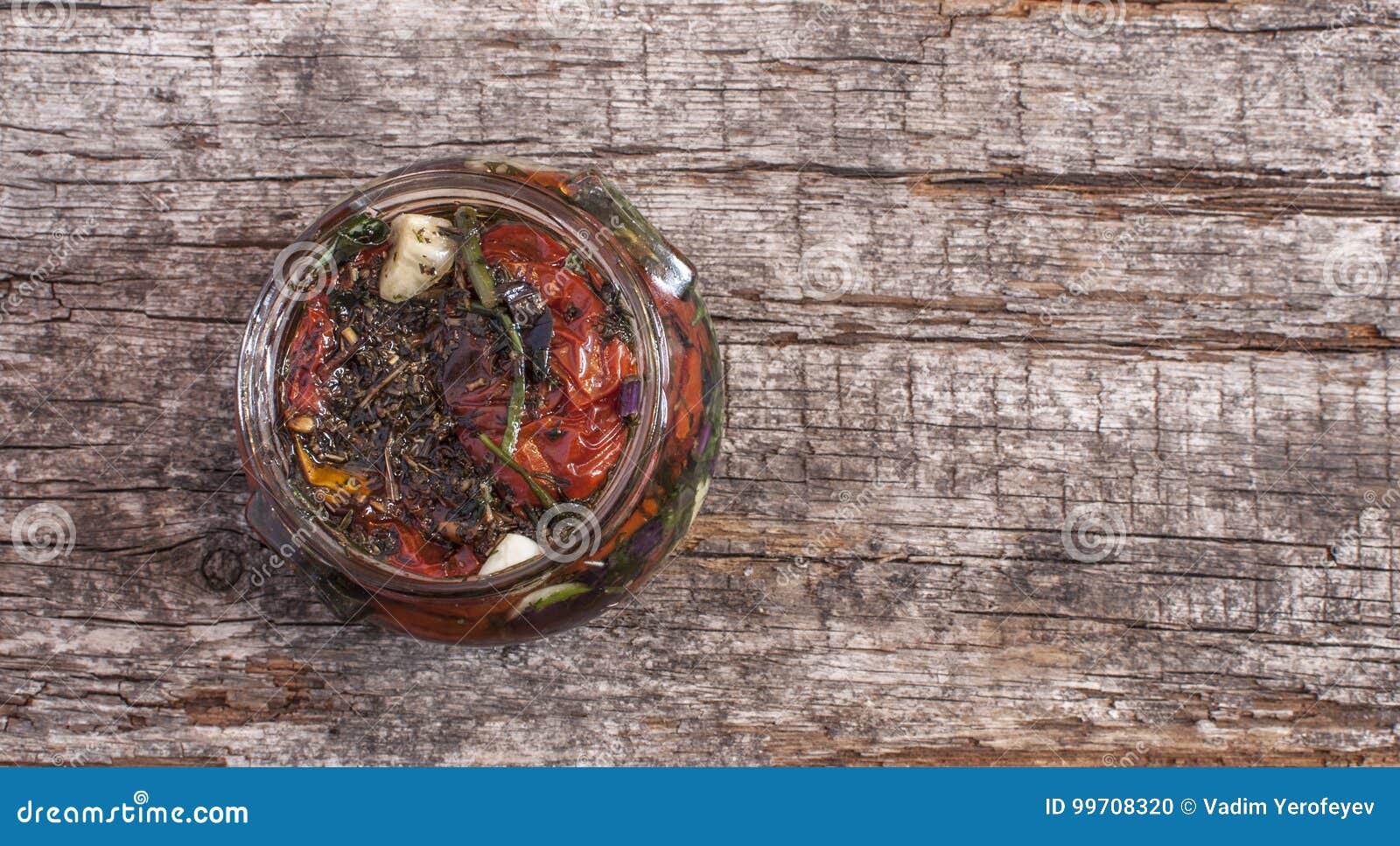 Sun Dried Tomatoes with Herbs and Olive Oil in Jar Stock Photo Image