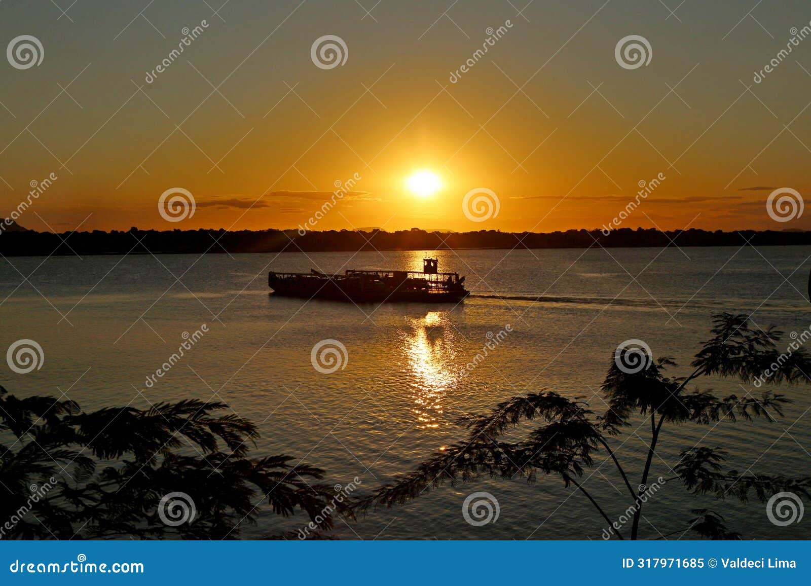 boat crossing tocantins river, maranhao at sunset