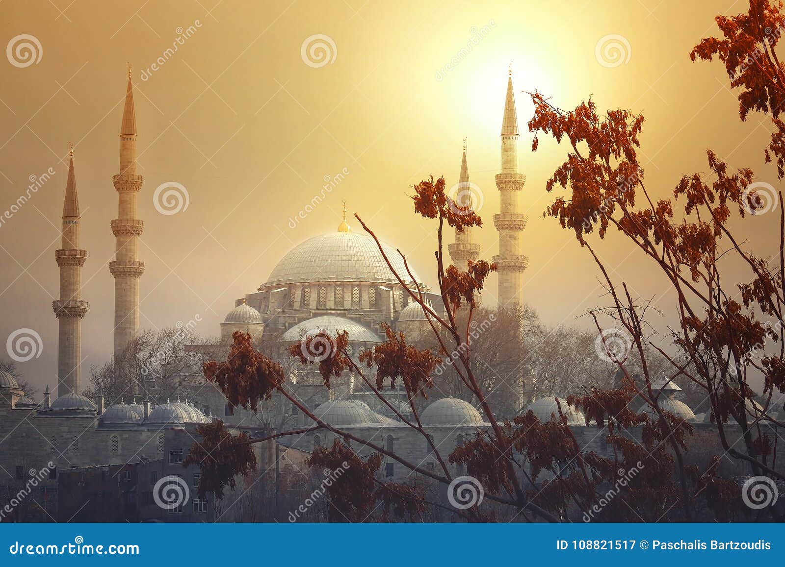the sun sets behind the suleymaniye mosque in istanbul
