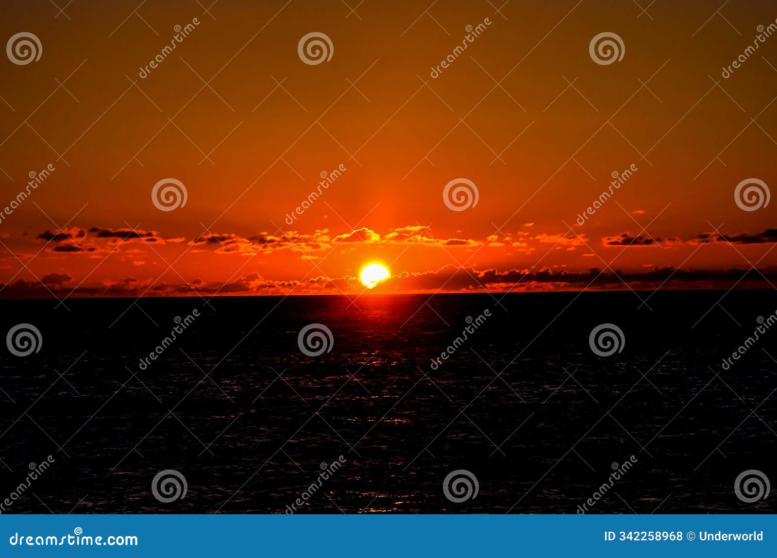 the sun is setting over the ocean, creating a beautiful and serene atmosphere