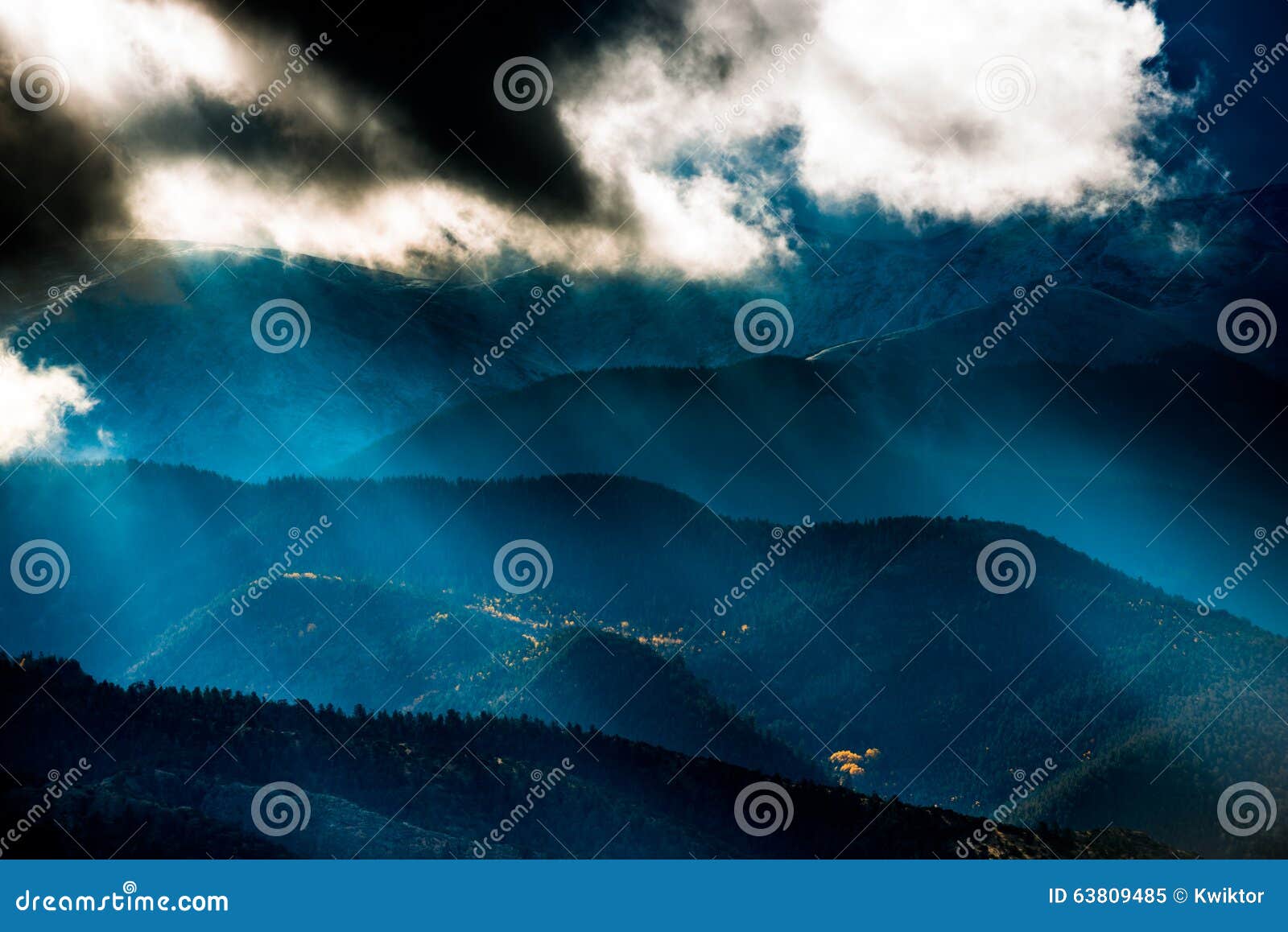 sun shining through the dark clouds over the mountains sand dune