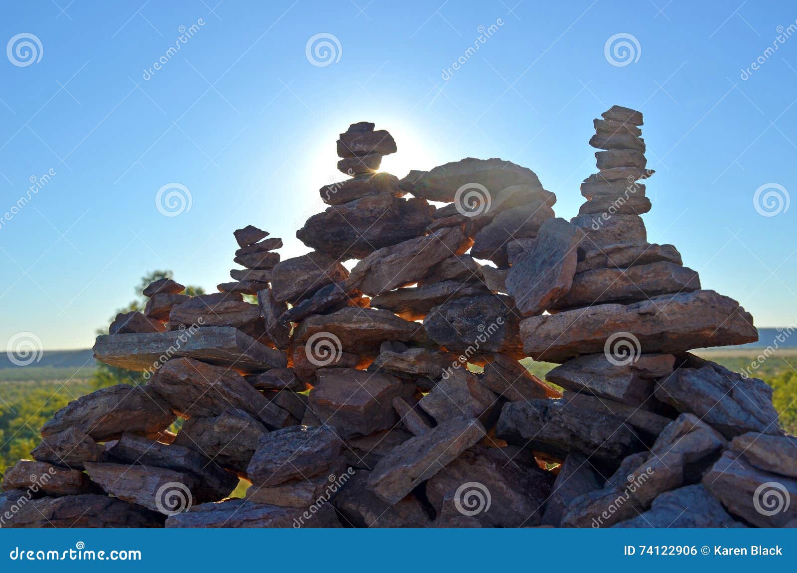 Sun Shining Through Rock Cairns Stock Photo Image Of Stacked Glow