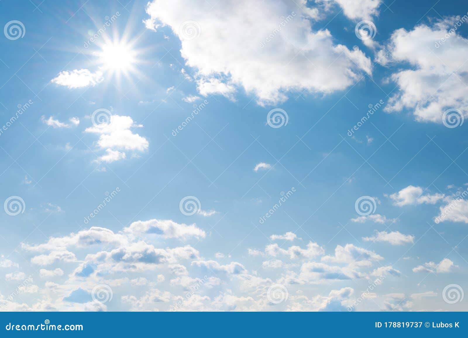 sun with sunrays on the blue sky with white clouds. daytime and good weather