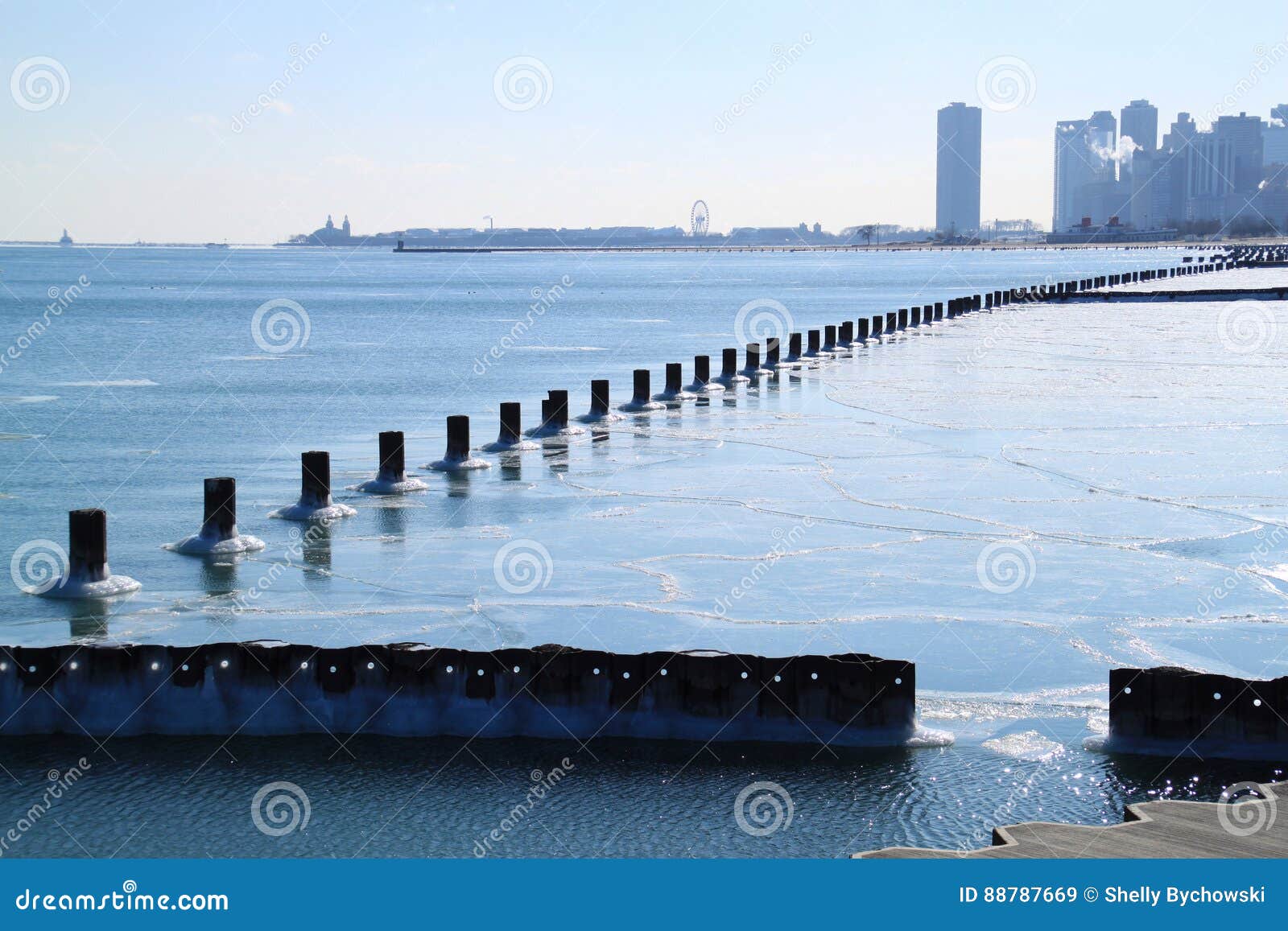 Sun Shining Over Chicago S Architectural Skyline And A Frozen Lake