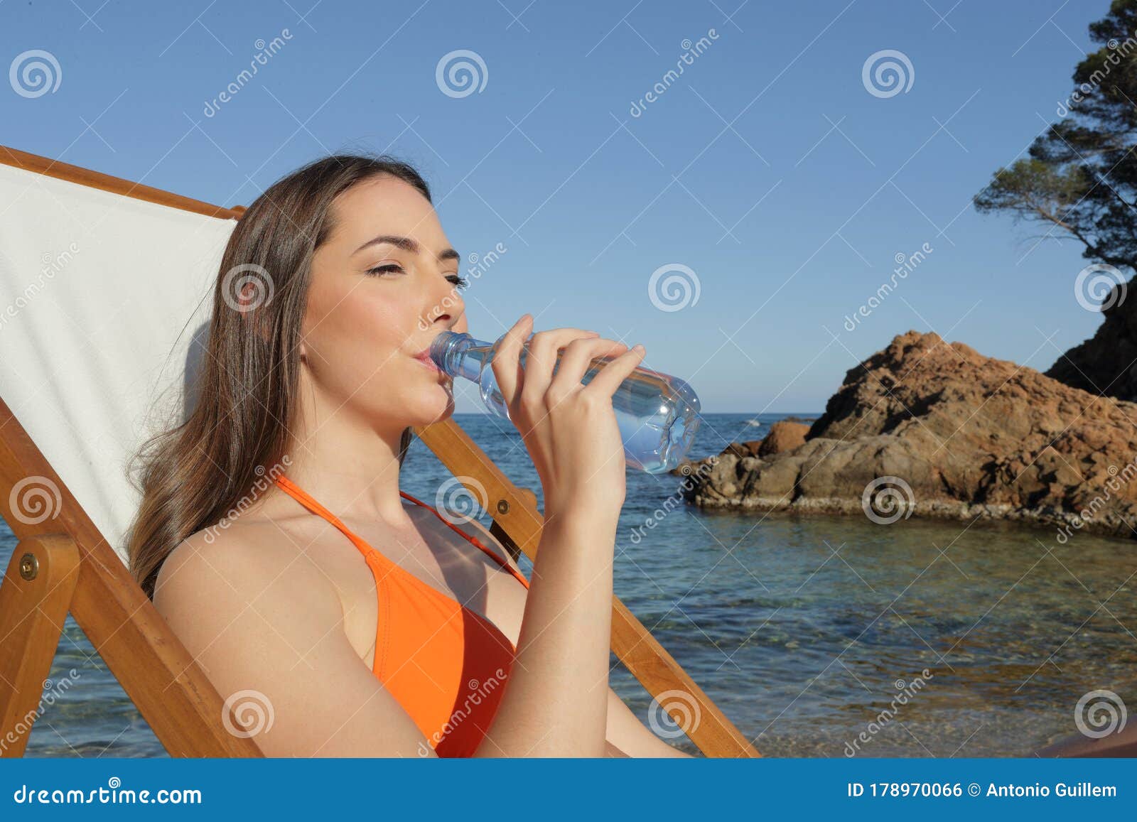 Sunbather Drinking Bottled Water on the Beach Stock Photo - Image of ...