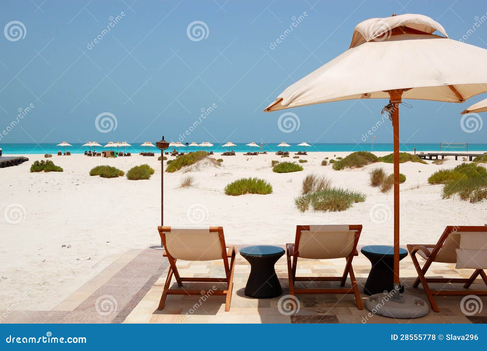 Sunbeds and Umbrellas at the Beach of Luxury Hotel Stock Photo Image