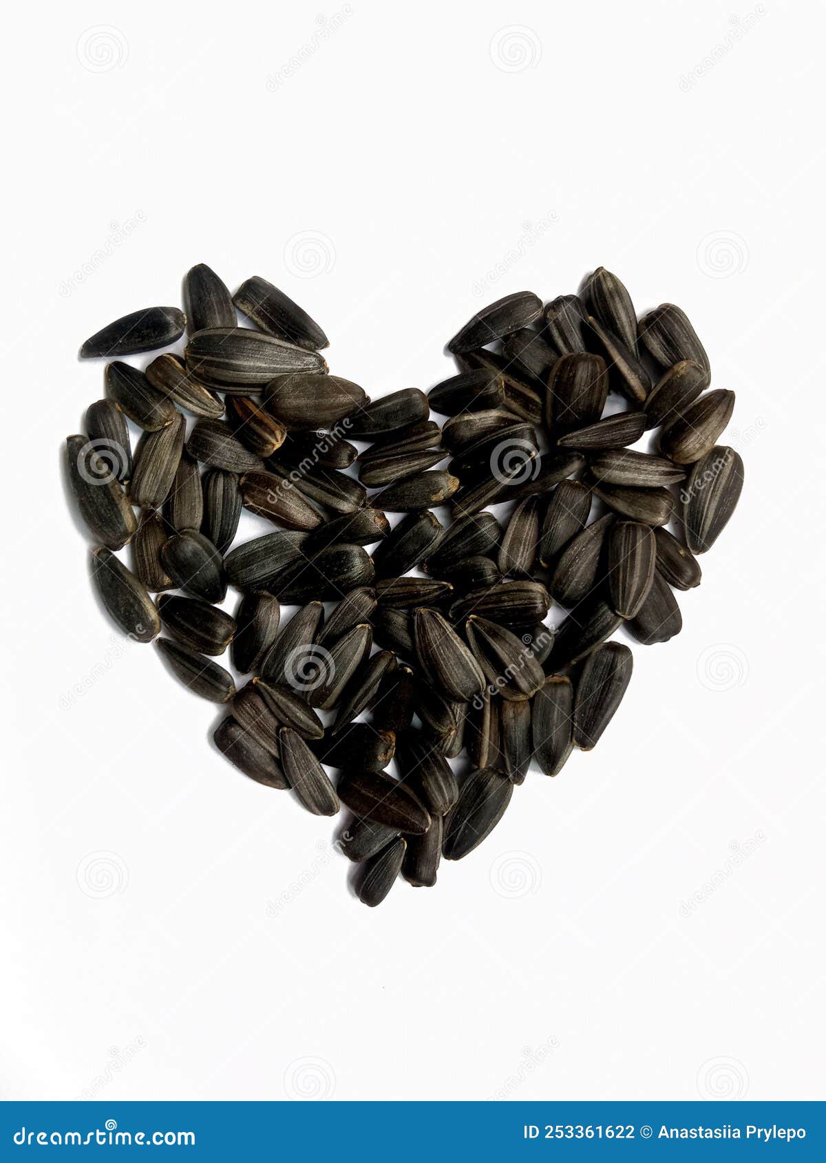 Sunflower Seeds Arranged in a Heart Shape on a White Background Stock
