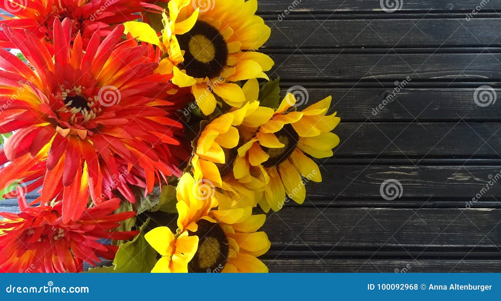 sunflowers and mums with wooden background. autumn decor.