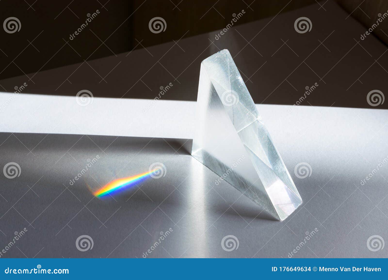 sunlight passes through a prism, creating a spectrum of colors