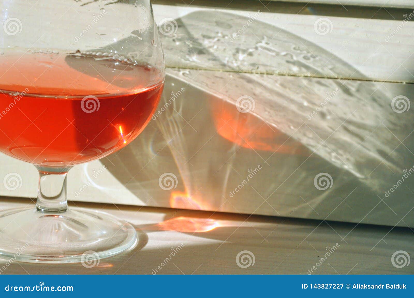 Sunlight Passing through a Glass of Rose Wine Creates a Stunning Effect