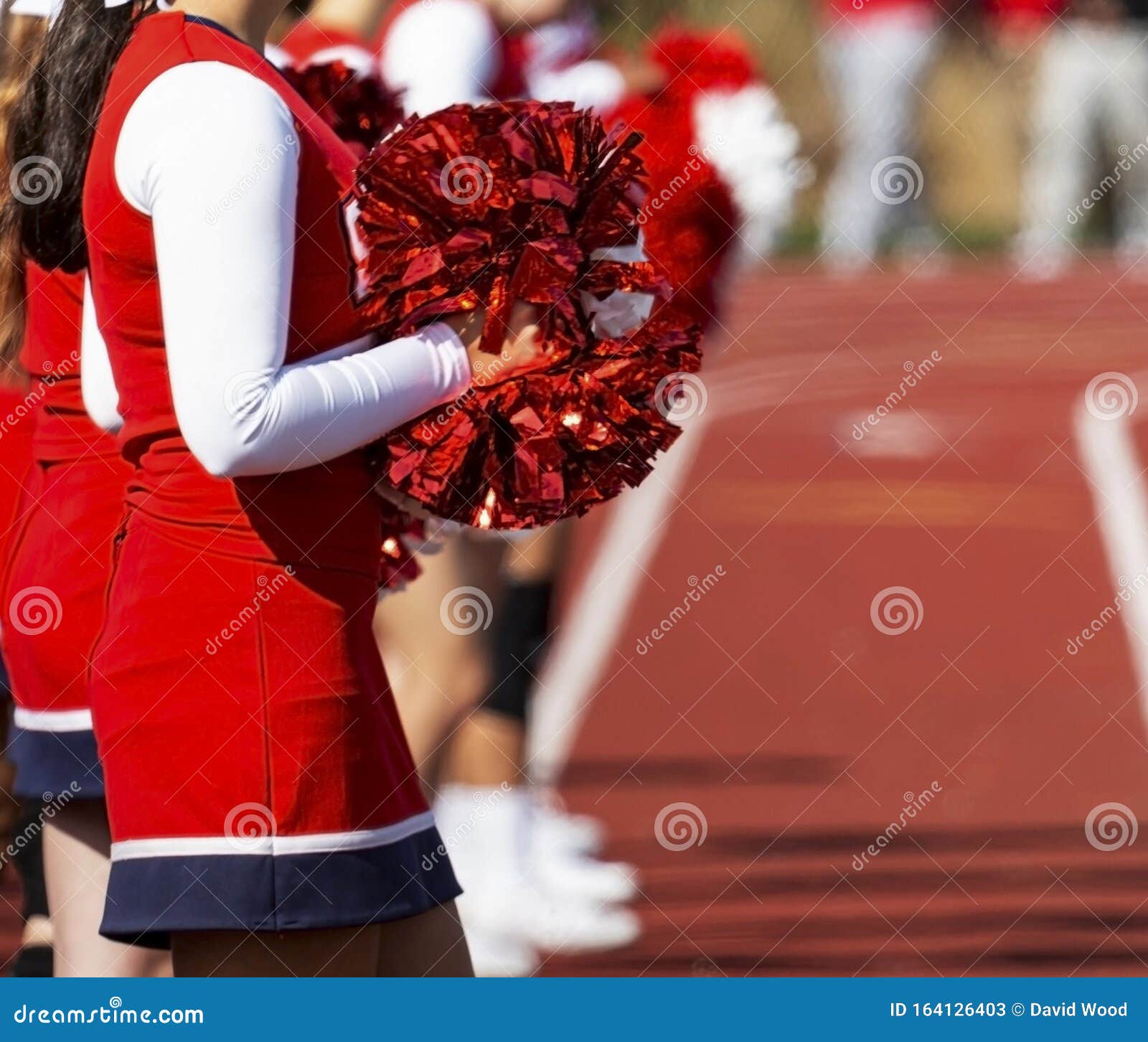 Red Pom Poms in the Sun Held by Cheerleader Stock Image - Image of athletic, inspire: 164126403