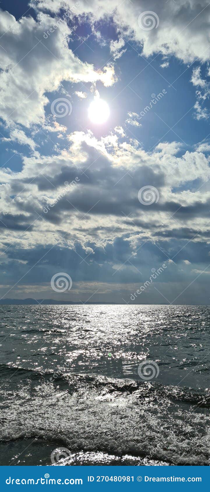 Sunlight on the Sea through the Filter of Rain Clouds Stock Image