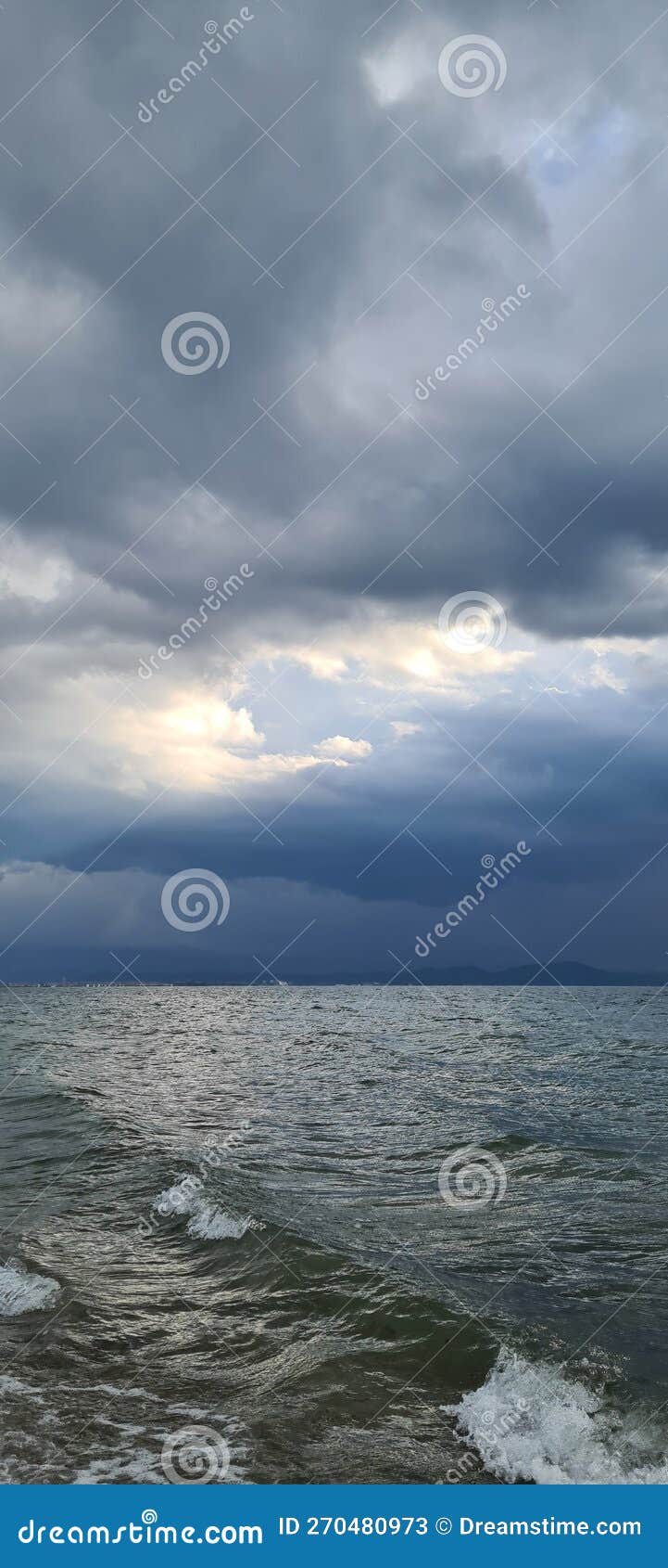 Sunlight on the Sea through the Filter of Rain Clouds Stock Image