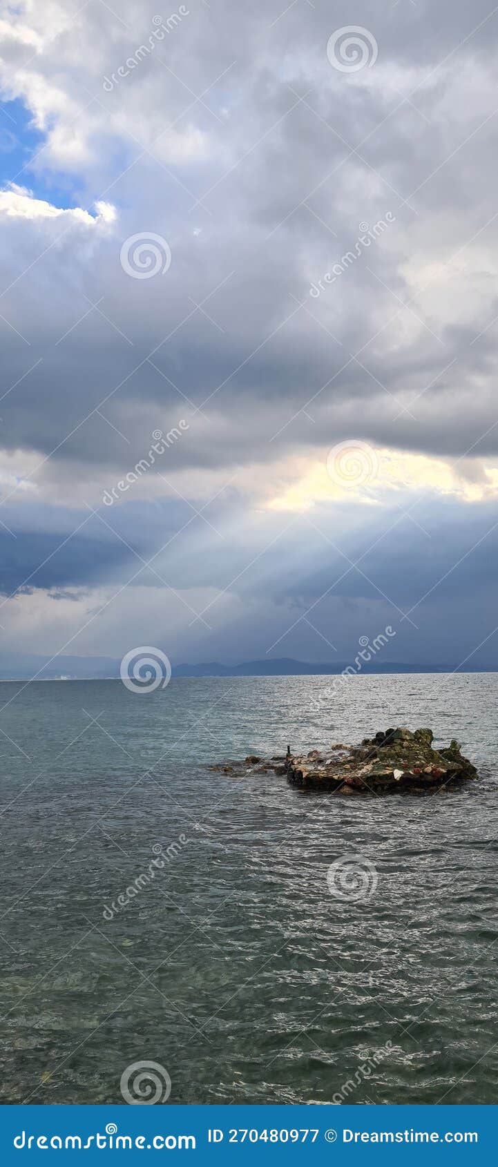 Sunlight on the Sea through the Filter of Rain Clouds Stock Image