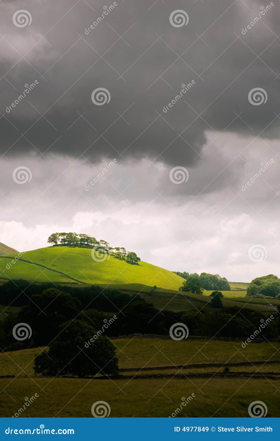 Sunlit hill. Stormy Yorkshire Dales National Park, North Yorkshire, England