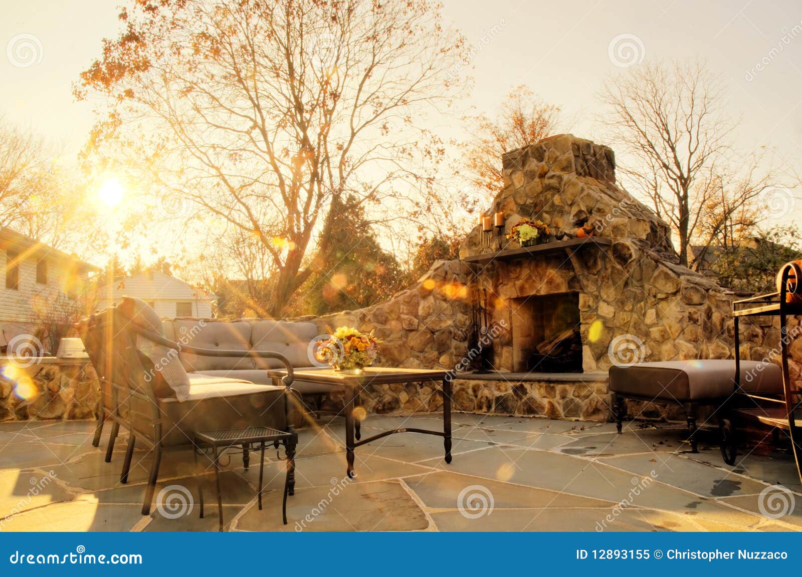 sunlit patio with stone fireplace