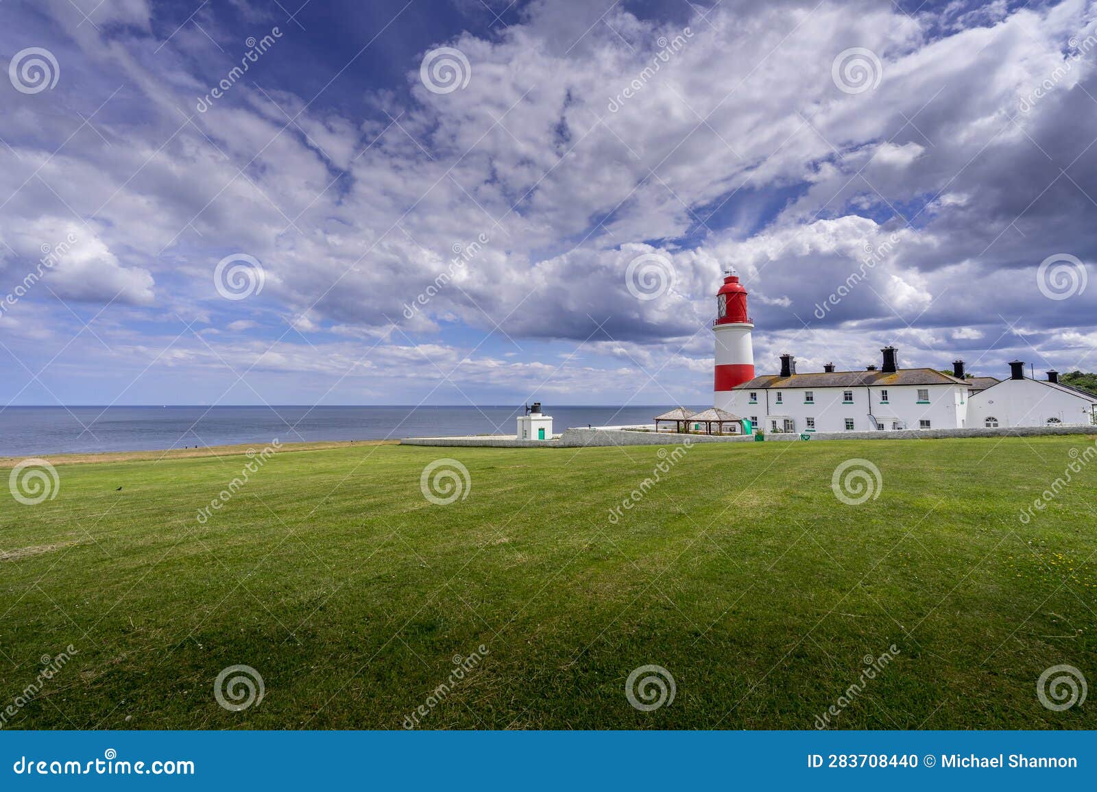 sunlit souther lighthouse and foxhorn building