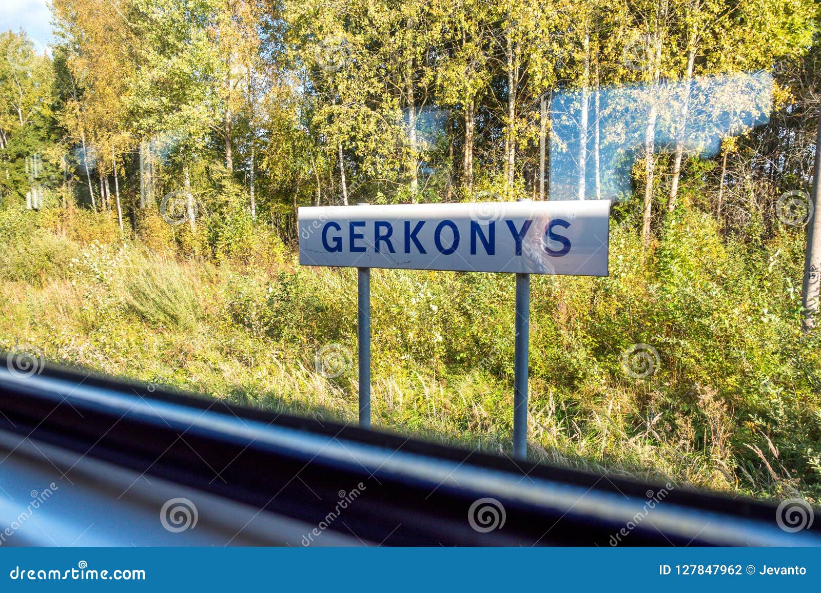 sunny day view of gerkonys town nameplate through train window traveling from visaginas to vilnius lithuania