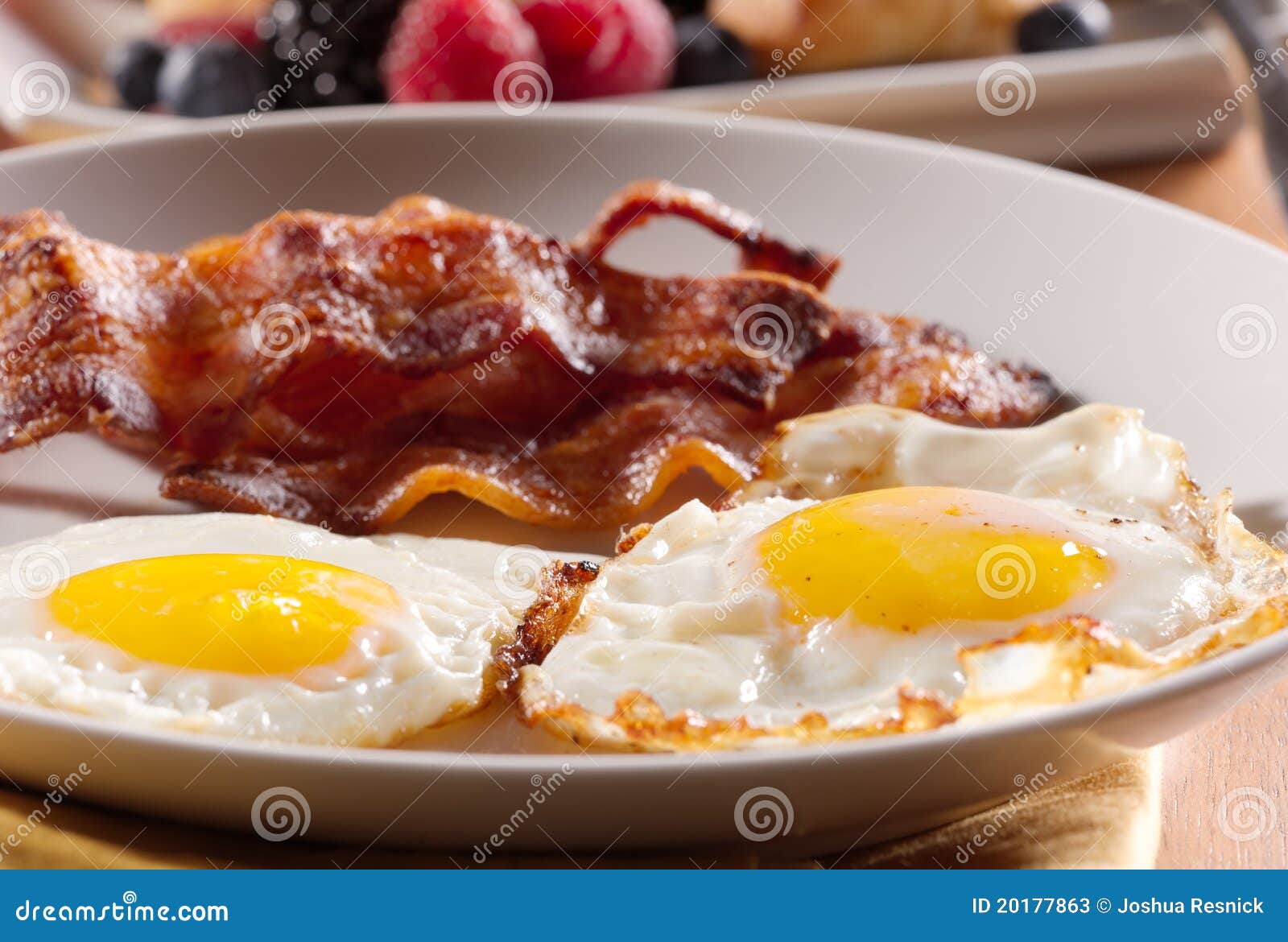 sunny side up eggs with fried bacon.