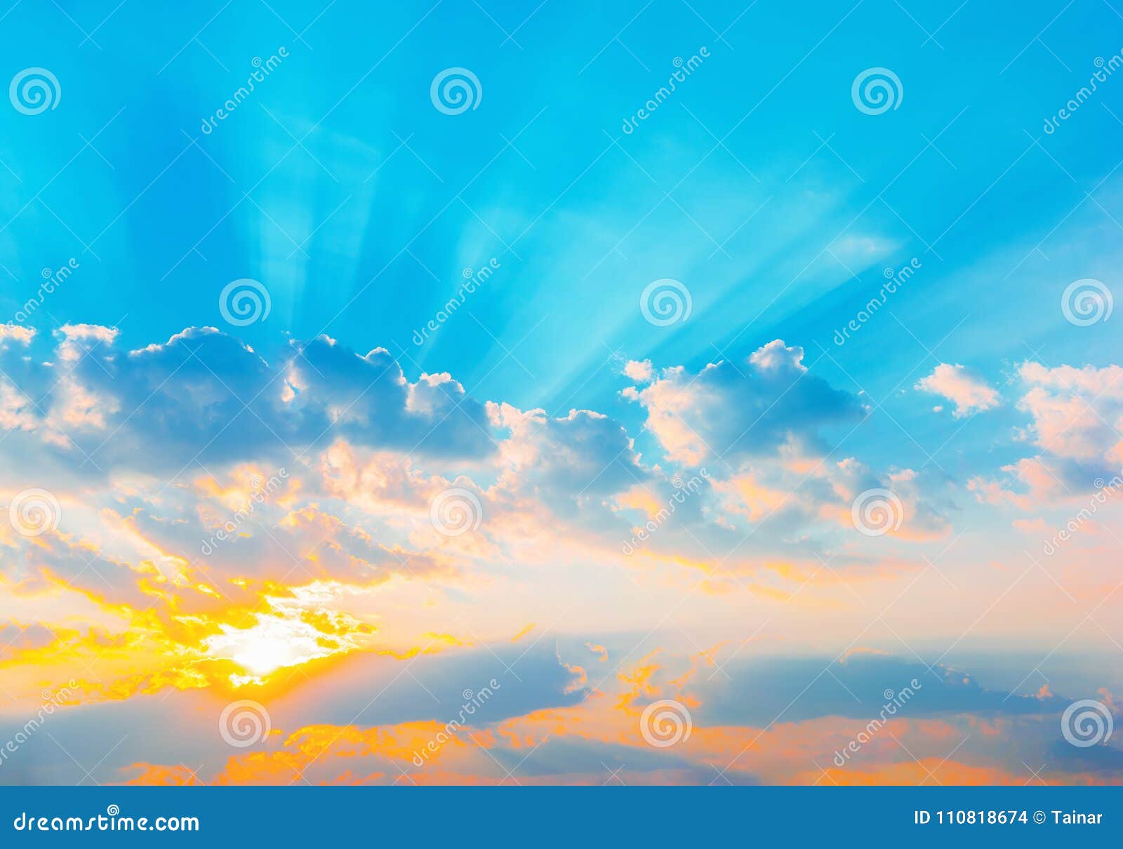 sunrise dramatic blue sky with orange sun rays breaking through the clouds. nature background. hope concept