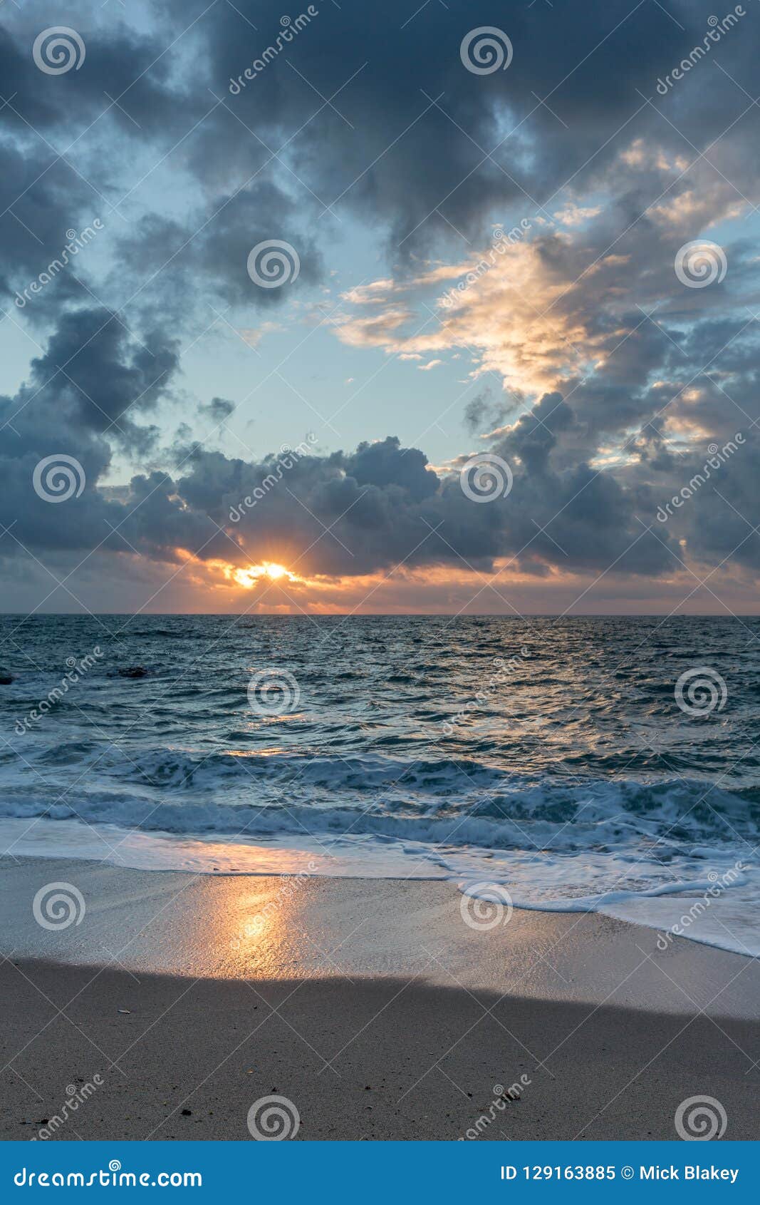 sunrise and dramatic sky, pentewan sands, cornwall